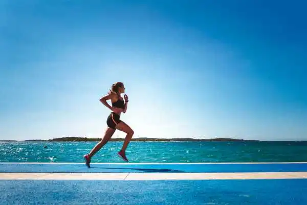 Woman running showing strong leg muscle Perth
